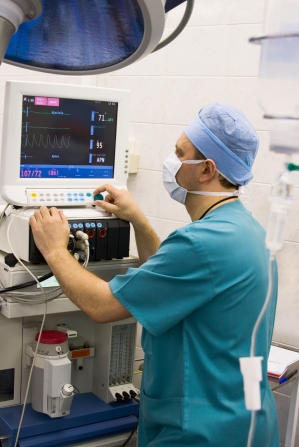 anaesthetist at monitor in operation room